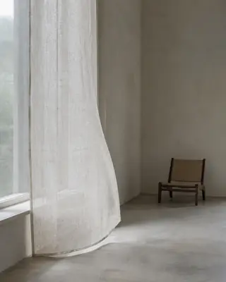 큰 창과 얇은 커튼 사이로 부드러운 빛이 드는 여백 많은 방